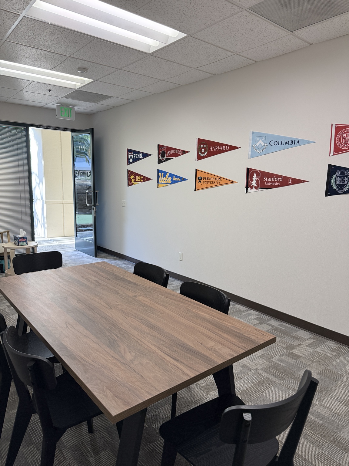 Meeting room with university pennants